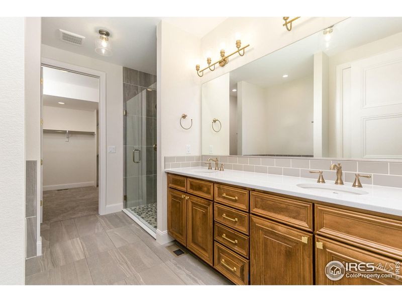 The primary ensuite bath has an extra-large double vanity with a lot of cabinetry below