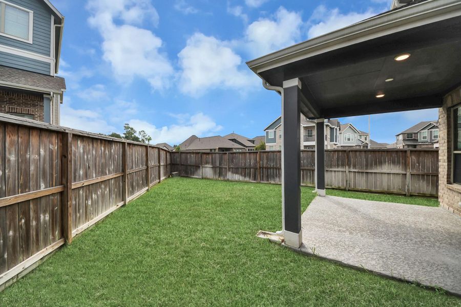 Exterior details and patio area of a home in The Groves, Humble (Image 30).