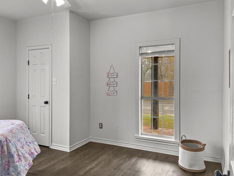 Bedroom #3 with dark wood-style floors and ceiling fan