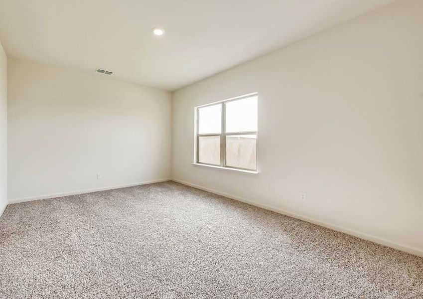 The master retreat has brown carpet and light walls.