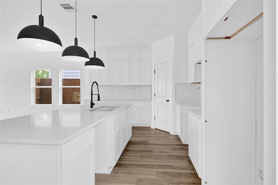 Chef’s kitchen with quartz countertops and black finishes. Chef’s kitchen with quartz countertops and black finishes.