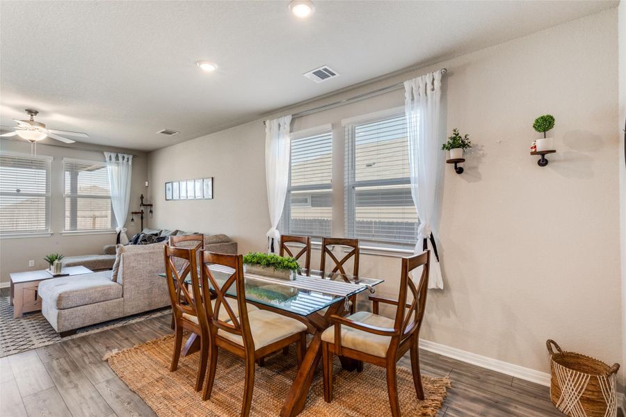 Dining room with wood finished floors and a ceiling fan