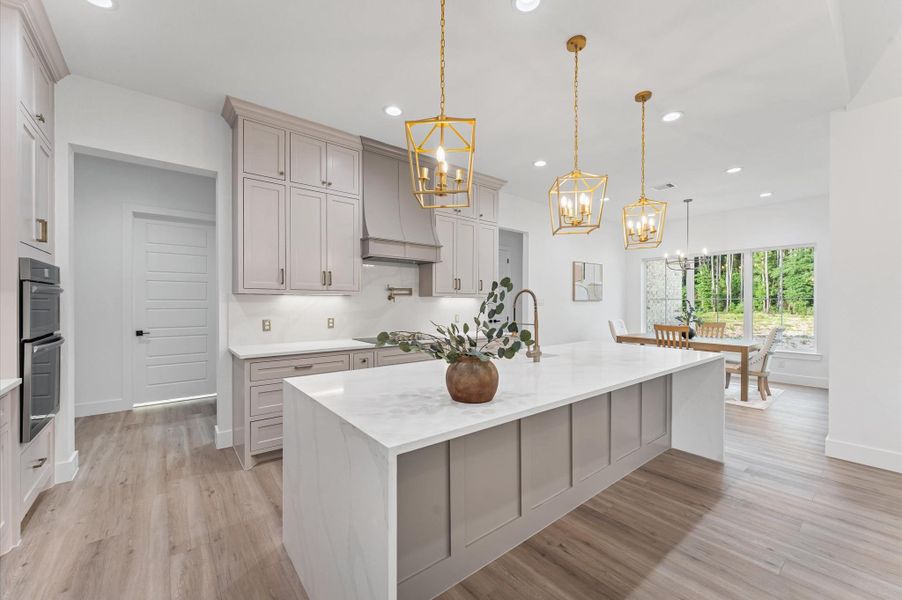 Oversized waterfall island offers bar seating and designer details.Abundant storage and soft-close drawers enhance the kitchen’s convenience and style. Oversized waterfall island offers bar seating and designer details.Abundant storage and soft-close drawers enhance the kitchen’s convenience and style.