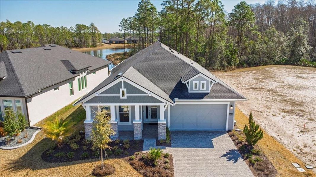 Front exterior of a new home in Woodhaven, Port Orange, FL, highlighting curb appeal (Image 2). Front exterior of a new home in Woodhaven, Port Orange, FL, highlighting curb appeal (Image 2).