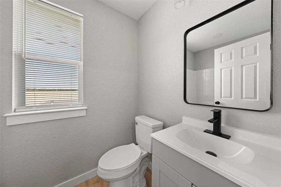 Bathroom with vanity and wood finished floors Bathroom with vanity and wood finished floors