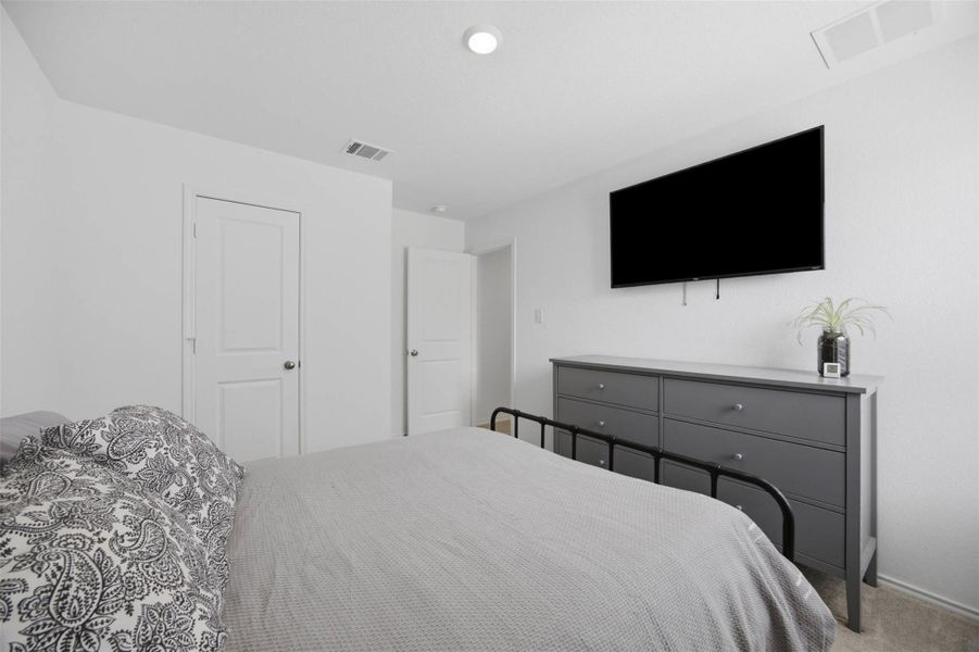 Crisp white walls and plush neutral carpeting define this relaxing private retreat.