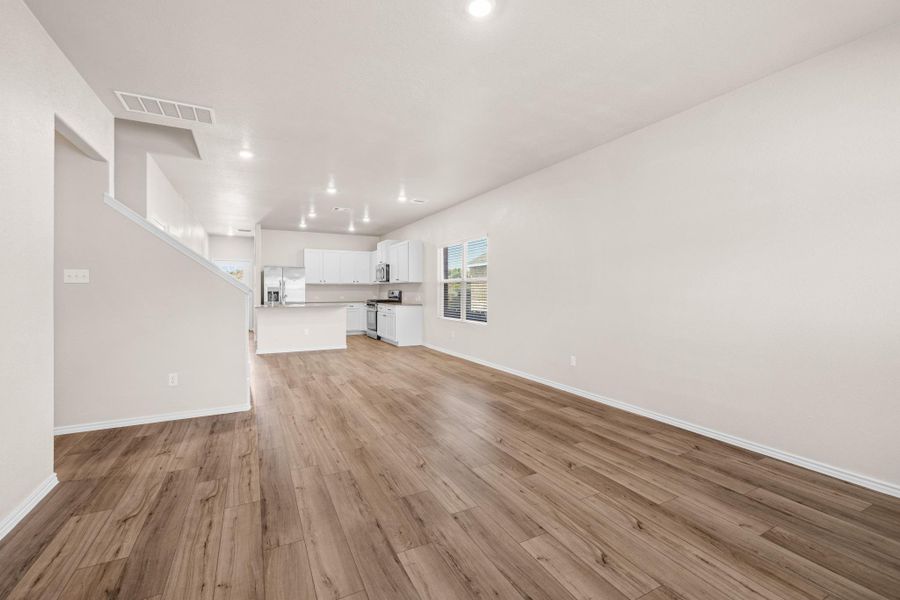 Unfurnished living room featuring light wood-type flooring and recessed lighting