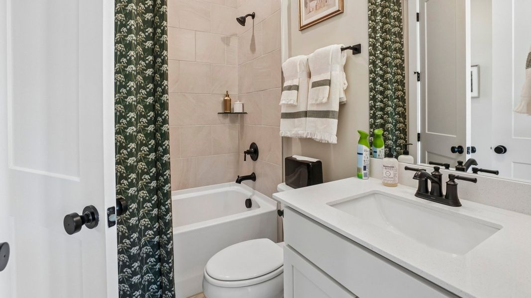 Secondary bathroom with tile lined shower Secondary bathroom with tile lined shower