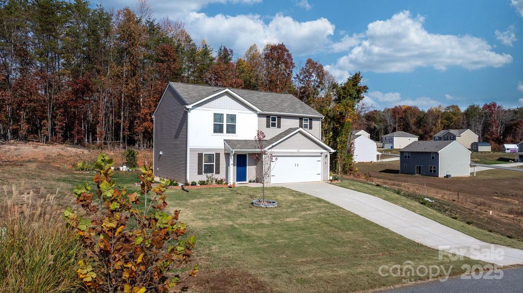 Front exterior of a new home in , Lenoir, NC, highlighting curb appeal (Image 1).