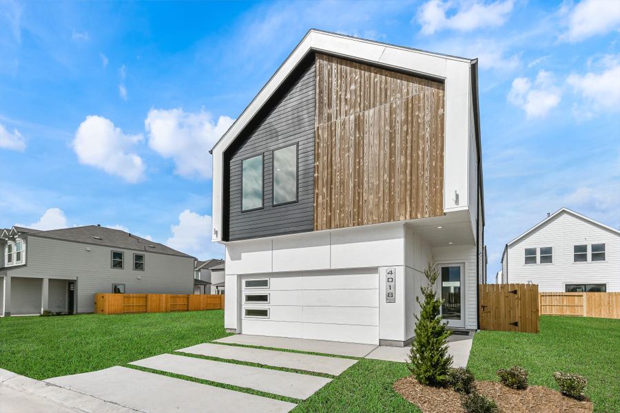 Front exterior of a new home in Antigua, Houston, TX, highlighting curb appeal (Image 2).