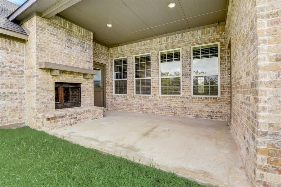 View of patio with an outdoor brick fireplace View of patio with an outdoor brick fireplace