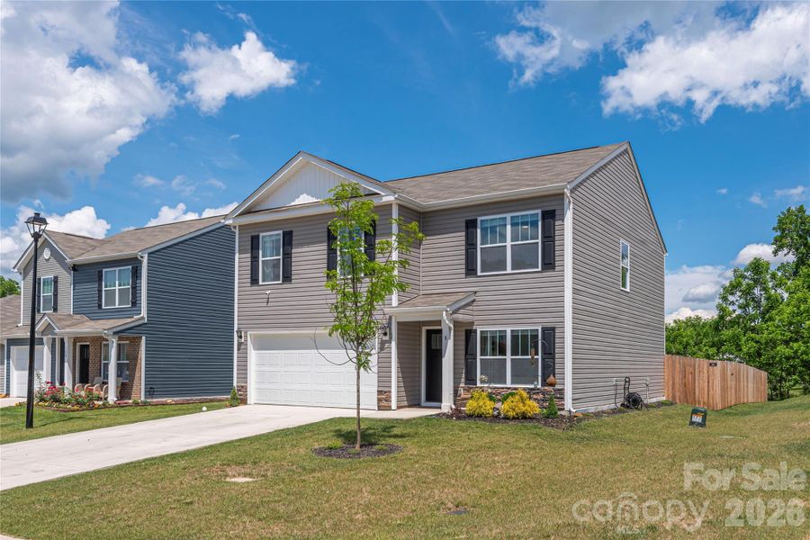 Front exterior of a new home in Patton Cove, Clyde, NC, highlighting curb appeal (Image 24).