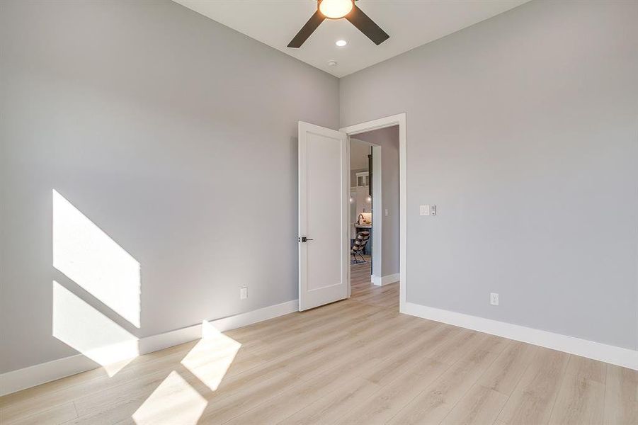 Empty room with light wood-type flooring and recessed lighting