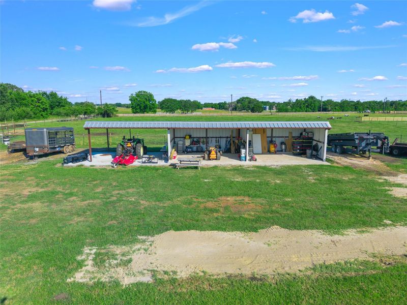 Concrete Pad Extension: The right side features a solid concrete foundation (perfect for a workshop area, clean storage, future stables, or grooming station), while the left side offers covered parking for the tractor or gathering space with a built in fire-pit.
