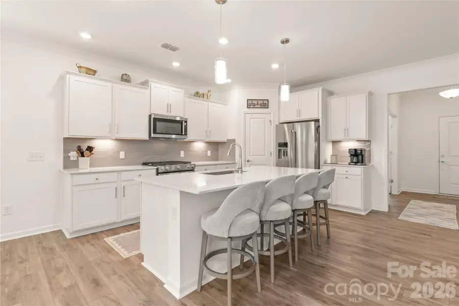 This central kitchen is the heart of the home. Open and a place for friends and family
