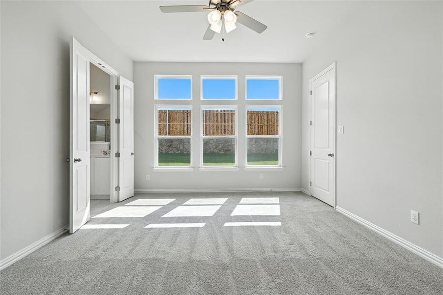 Spare room with carpet floors and a ceiling fan