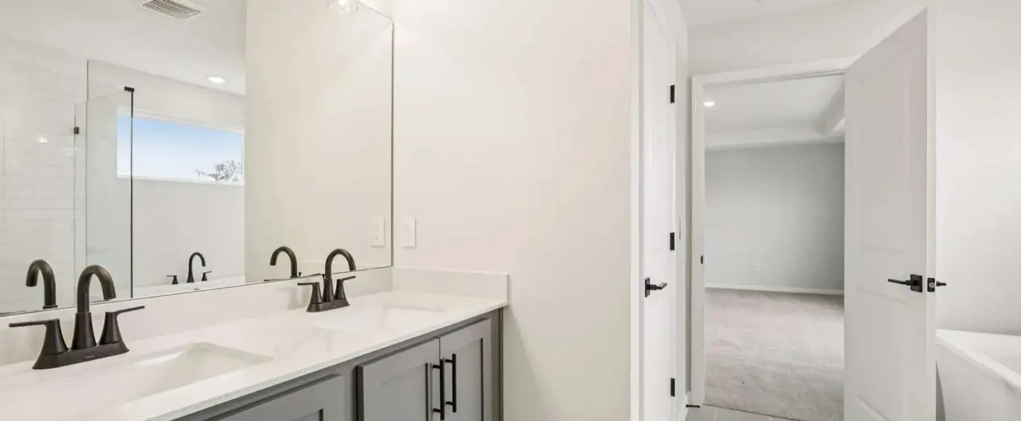 Primary bathroom with double sinks will feature aspects of AW Collection® Coastal - Representative images and renderings are for illustrative purposes. Actual structural options and design finishes of home may vary.