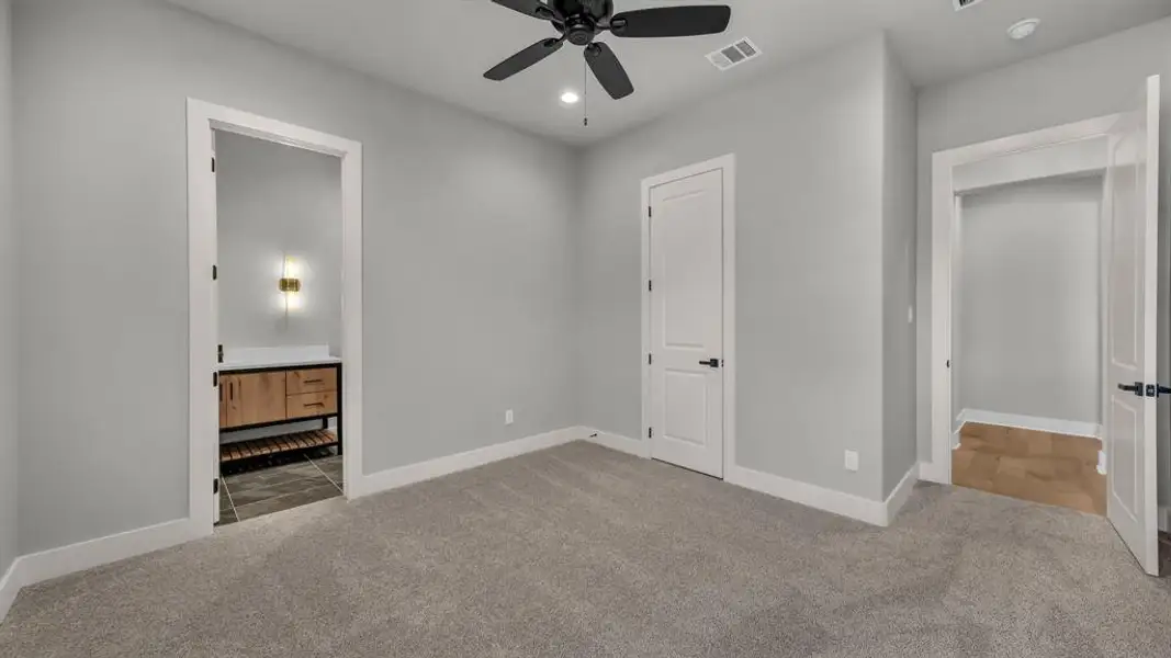 Carpeted room with a ceiling fan, recessed lighting, and light gray walls Carpeted room with a ceiling fan, recessed lighting, and light gray walls