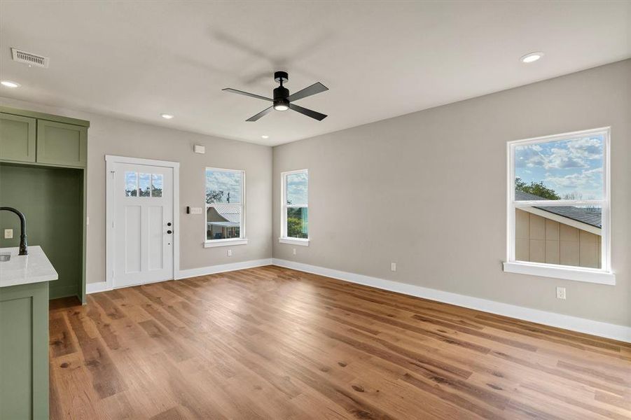 Foyer entrance with recessed lighting, light wood-style flooring, healthy amount of natural light, and a ceiling fan