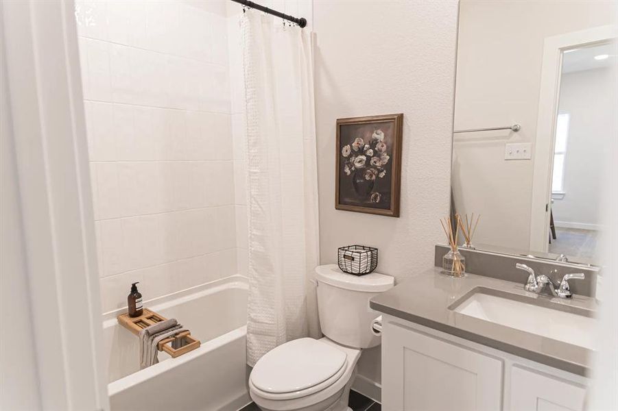 Full bath featuring vanity and shower / tub combo with curtain Full bath featuring vanity and shower / tub combo with curtain