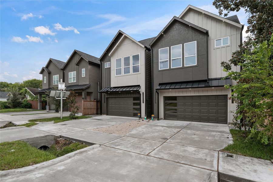 Daytime view showcasing the paired homes with inverse exterior palettes, creating a bold yet balanced architectural statement. Daytime view showcasing the paired homes with inverse exterior palettes, creating a bold yet balanced architectural statement.