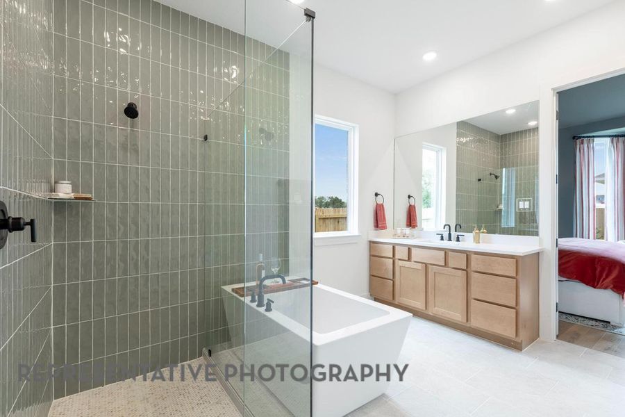 Full bath with a freestanding bath, walk in shower, vanity, connected bathroom, and recessed lighting Full bath with a freestanding bath, walk in shower, vanity, connected bathroom, and recessed lighting