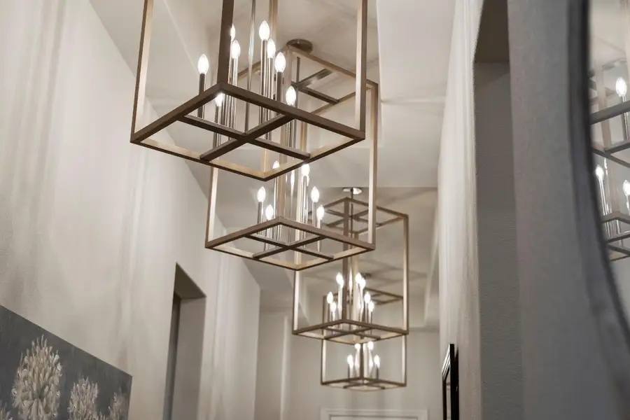 Foyer lined with 4 designer chandeliers Foyer lined with 4 designer chandeliers