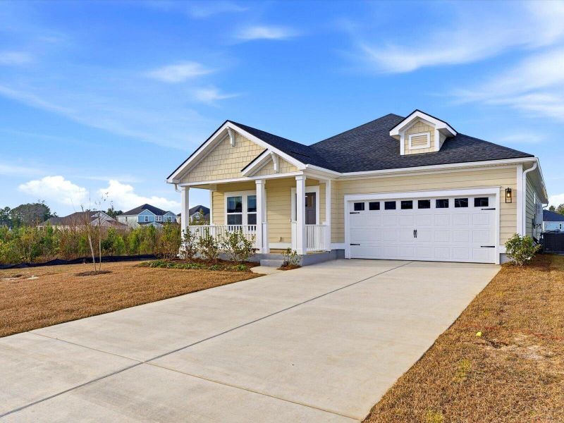 Front exterior of a new home in The Coves at Lakes of Cane Bay, Summerville, SC, highlighting curb appeal (Image 2). Front exterior of a new home in The Coves at Lakes of Cane Bay, Summerville, SC, highlighting curb appeal (Image 2).