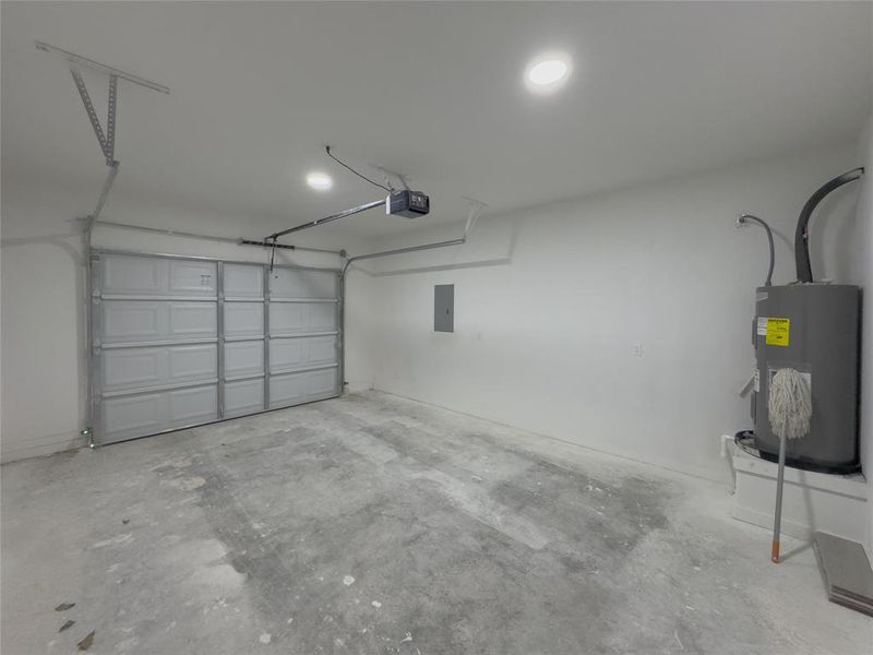 Garage featuring a garage door opener and water heater