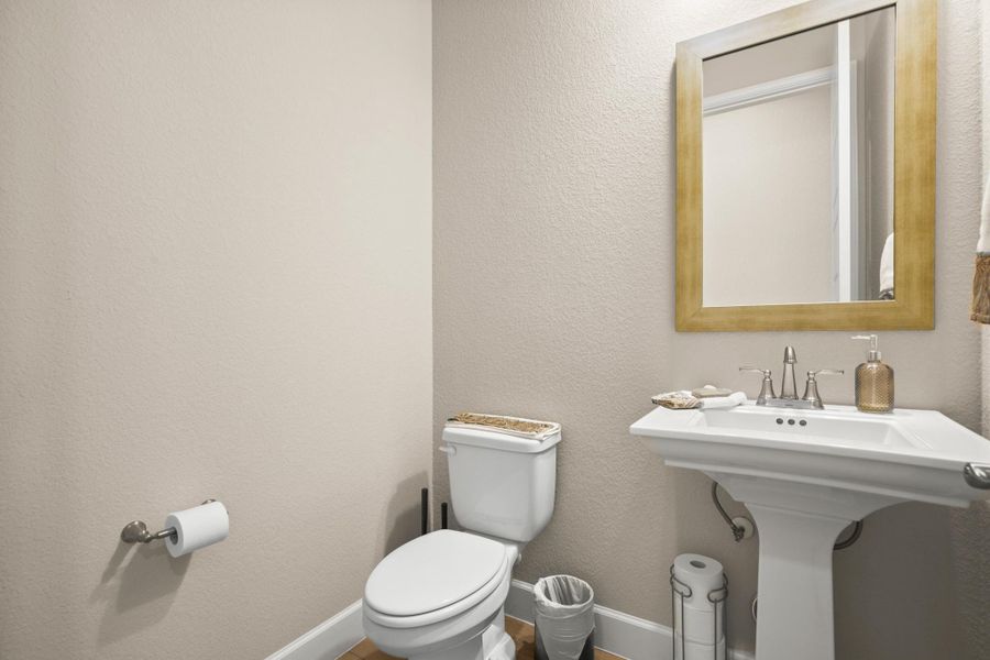 Half bathroom with a textured wall Half bathroom with a textured wall