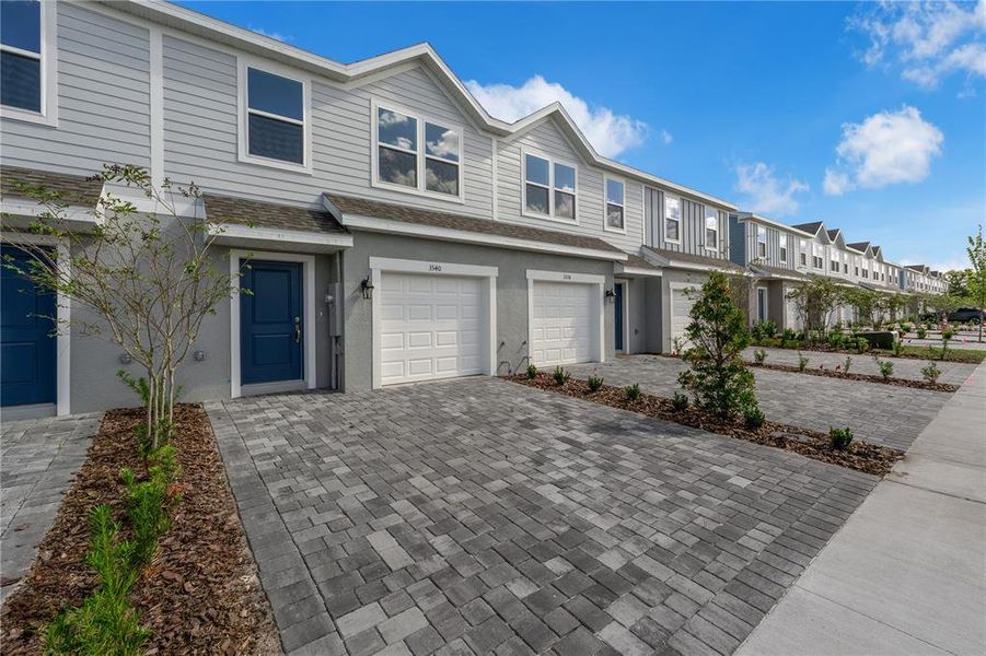 Front exterior of a new home in Avalon Park Tavares Townhomes, Tavares, FL, highlighting curb appeal (Image 1). Front exterior of a new home in Avalon Park Tavares Townhomes, Tavares, FL, highlighting curb appeal (Image 1).