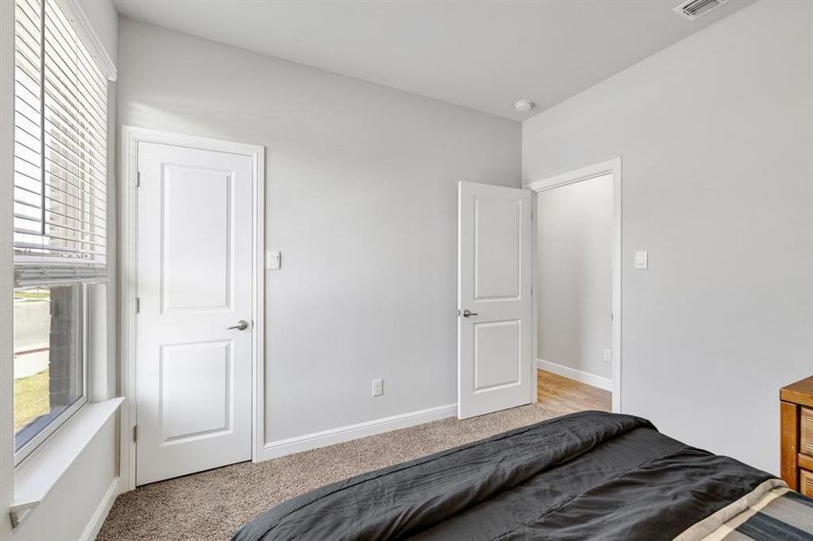 Carpeted bedroom with baseboards