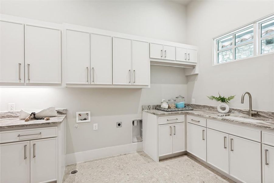 Laundr room offers room for full size washer and dryer and room for a second refrigerator.