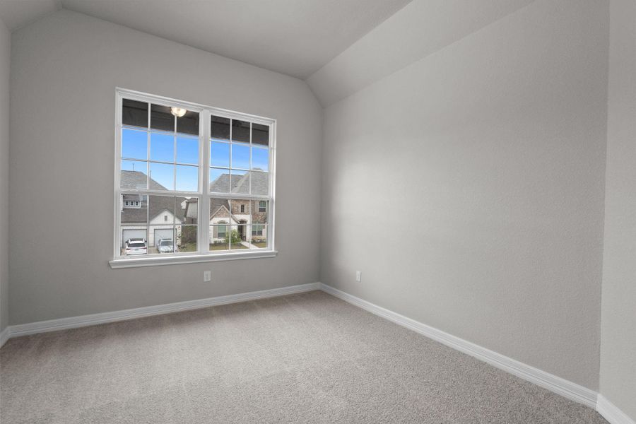 Your secondary bedroom features plush carpet, fresh paint, closet, and a large window that lets in plenty of natural lighting.
