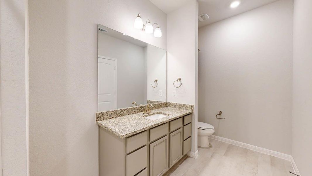 Bathroom with vanity and baseboards