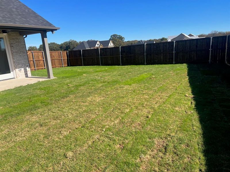 Large wood privacy fenced flat backyard. Irrigated and sodded