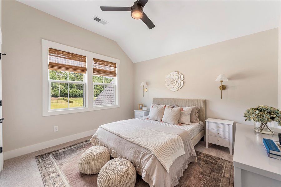 This airy bedroom features high ceilings and ample