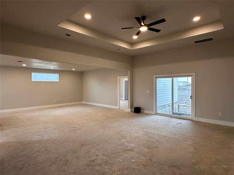 Unfurnished room with recessed lighting, ceiling fan, plenty of natural light, and a raised ceiling