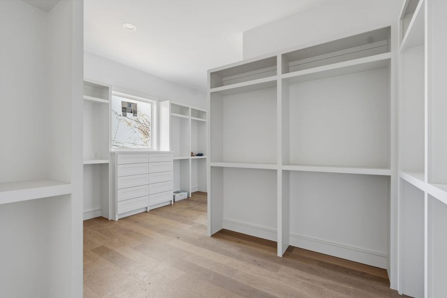 Primary walk in closet designed with a spacious layout and thoughtfully planned zones for hanging and storage.