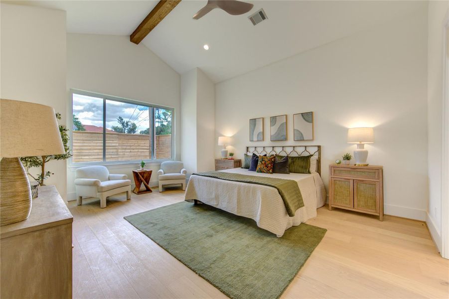 The primary suite offers generous proportions, vaulted ceilings, and a peaceful sitting area bathed in natural light.