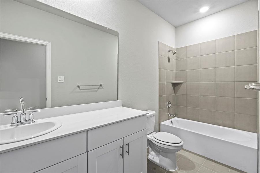 Bathroom with vanity, shower combination, and tile patterned floors Bathroom with vanity, shower combination, and tile patterned floors