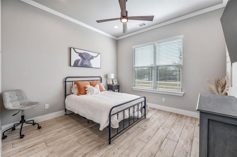 Bedroom with ornamental molding, light wood-style flooring, ceiling fan, and recessed lighting