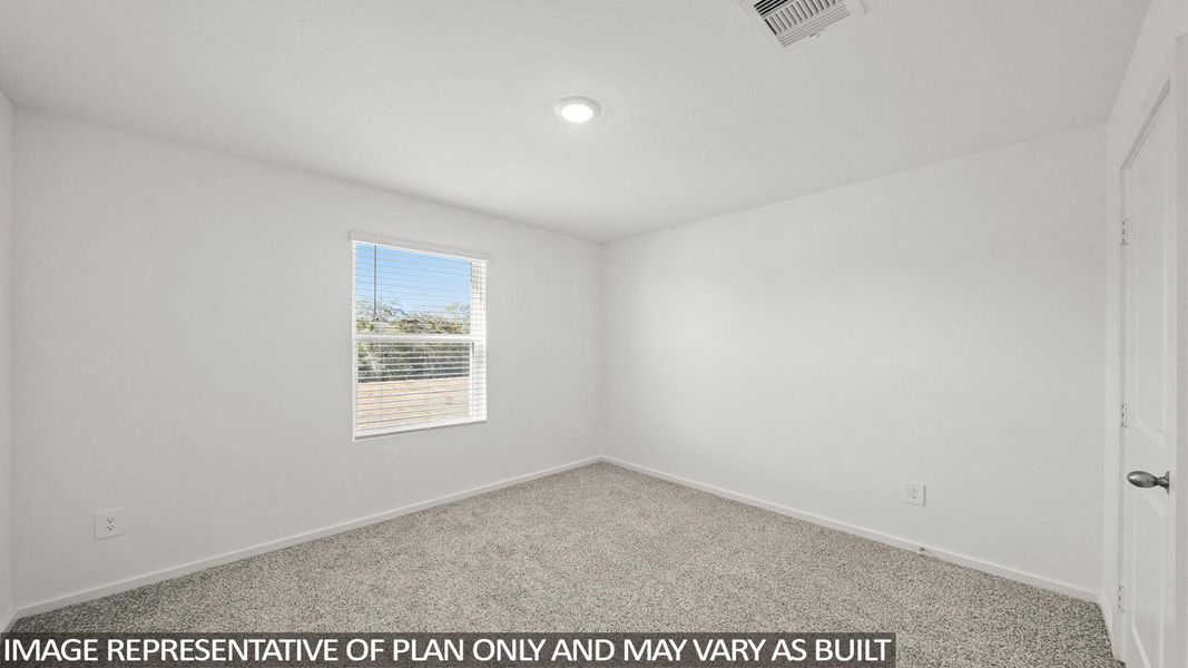 A well-lit bedroom with fresh carpet awaits personal touches.