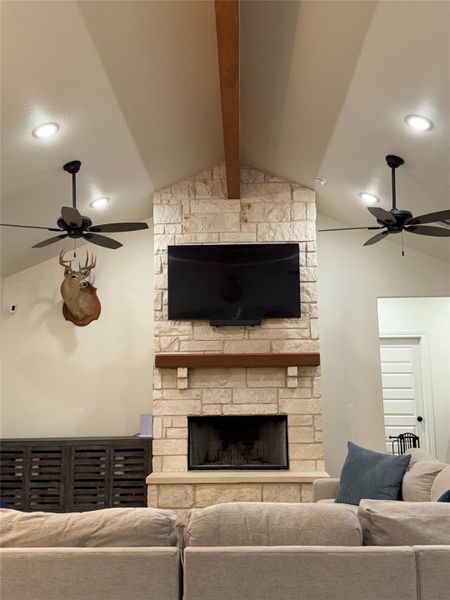Living area with ceiling fan, a stone fireplace, and recessed lighting Living area with ceiling fan, a stone fireplace, and recessed lighting