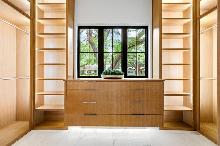 Spacious closet featuring light marble finish flooring