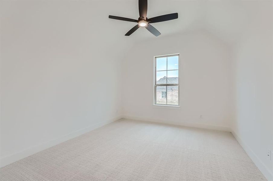 Additional living space featuring carpet floors, lofted ceiling, and ceiling fan