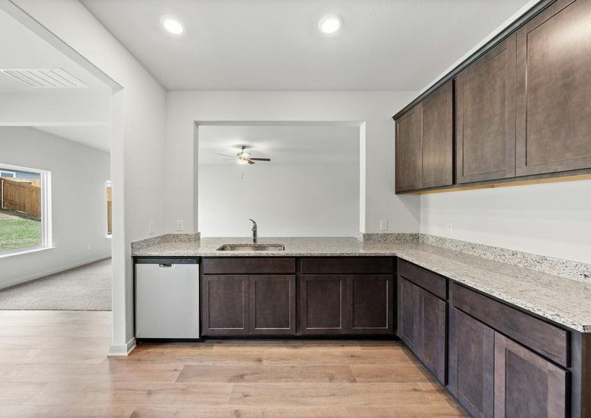 The kitchen has sprawling granite countertops.