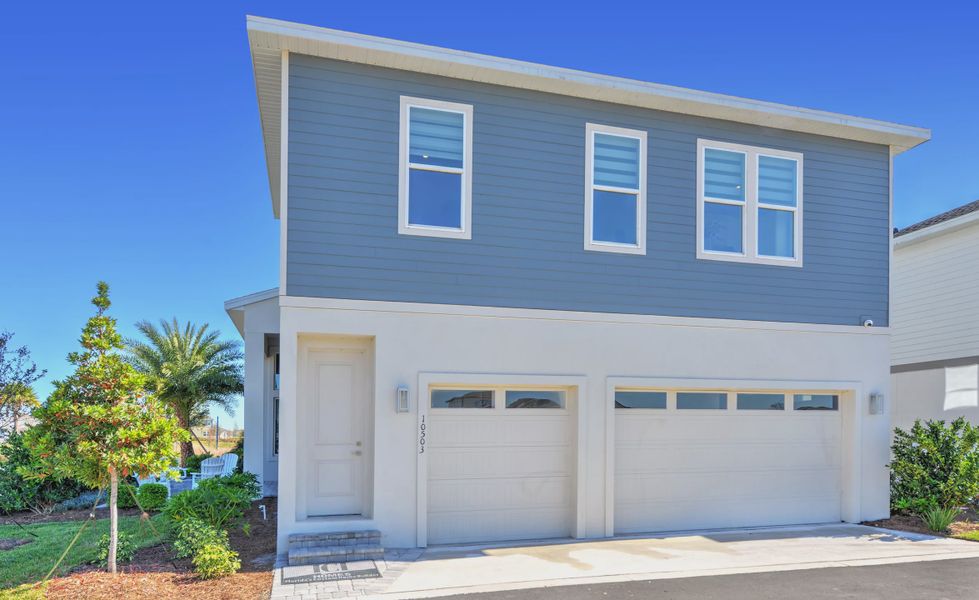 Front exterior of a new home in Laureate Park, Orlando, FL, highlighting curb appeal (Image 21).
