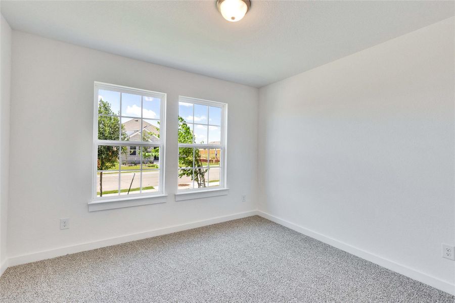 Empty room with baseboards and carpet floors Empty room with baseboards and carpet floors