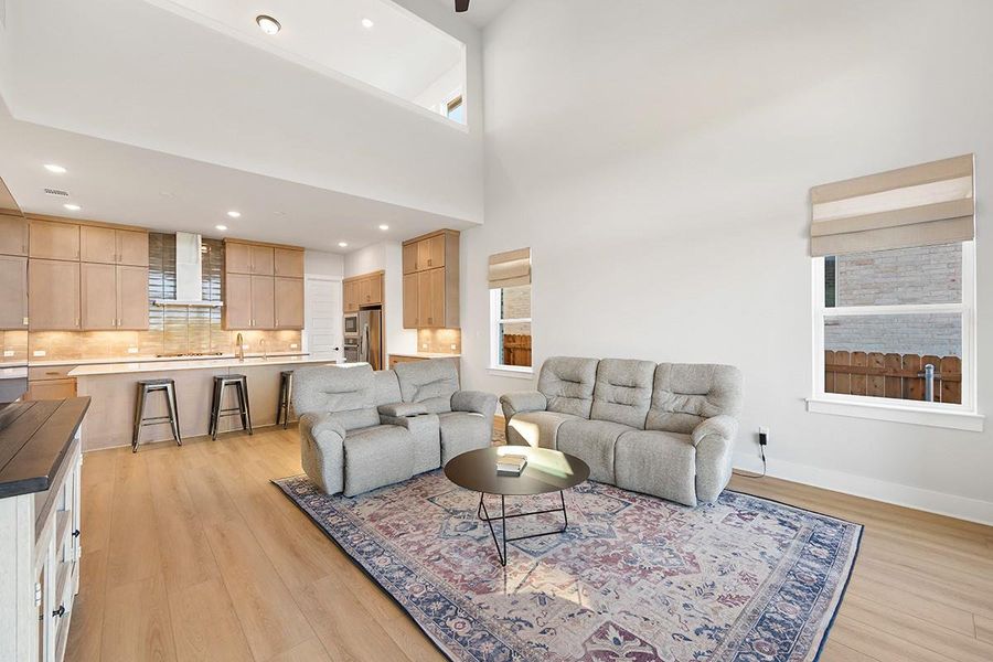 High ceilings and clean architectural lines define this welcoming living space and modern kitchen.